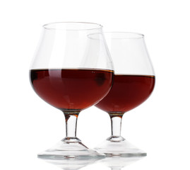 Glasses of brandy isolated on white