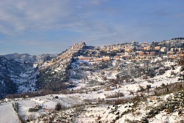 Naklejka premium Paese di collina sotto la neve