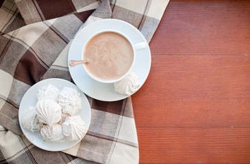 coffee and meringues with a brown cloth