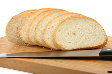 The cut bread on a chopping board with a knife