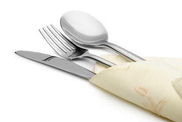 Spoon, fork and a knife lie on serviette