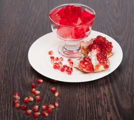 Red jelly on a porcelain plate with pomegranate