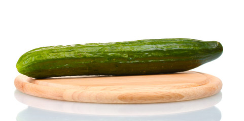long cucumber on wooden cutting board isolated on white