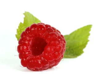 Red raspberry with green leaves on the withe background