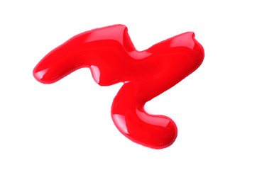 Red nail polish drops isolated on white