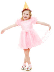 A girl in a pink dress and hat dances on a white background.