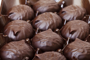 box of sweet marshmallow in chocolate, closeup