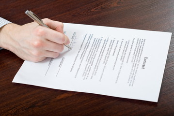 Signing contract by businessman