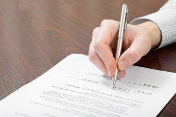 Signing contract by businessman