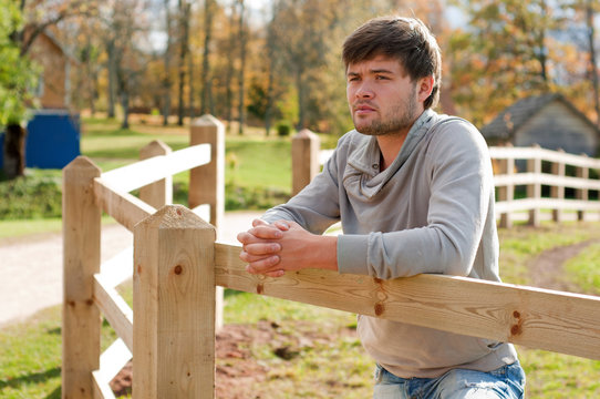 Portrait of young guy in country field