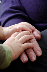 Hands of the old woman and child