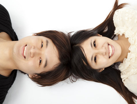 young lovely couple lying  floor and looking the camera
