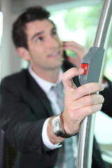 Businessman pressing button on bus