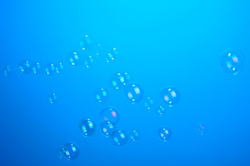 Soap bubbles on blue background
