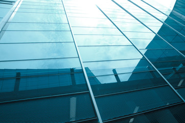 glass office building with clouds and sky