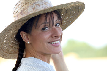 Attractive brunette wearing straw hat