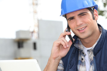 Construction worker using a mobile phone