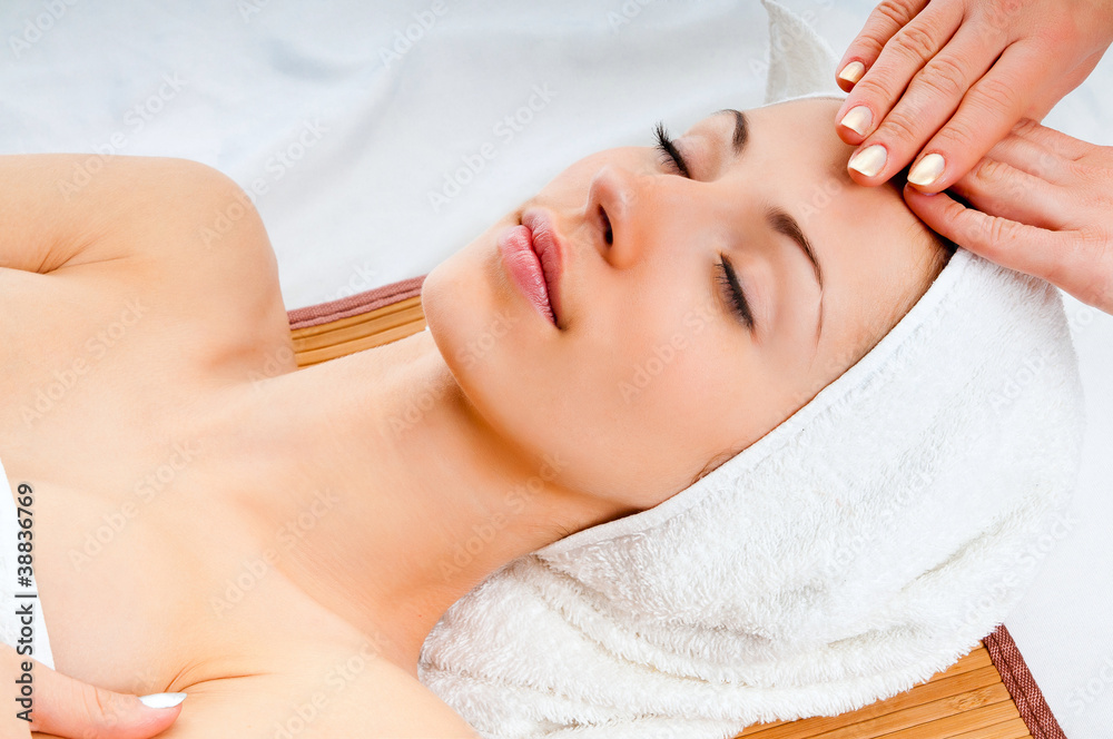 Wall mural woman receiving facial massage