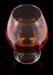 cognac in goblet isolated on black background
