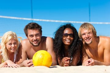 Friends playing beach volleyball