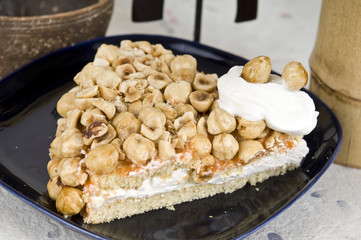Cake with nuts, jam and cream