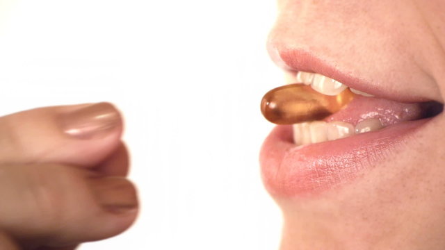 HD - Woman taking a pill with water. Macro shot