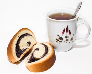 Rolled biscuit with poppy and a cup of tea