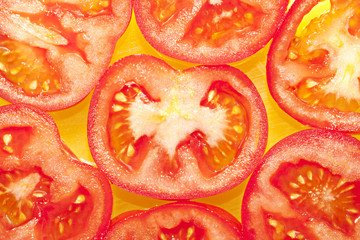 Tomato pieces on a yellow background