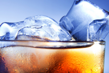 A fresh glass of cola with ice. Close up