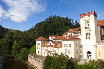 Grand old spa resort next to a river surrounded by forests