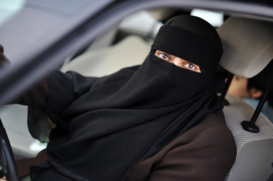 Muslim middle eastern female driver wearing veil