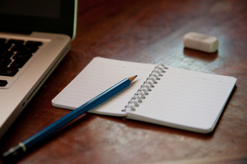 Laptop, notebook and pencil on the table