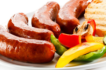Grilled sausages, bread and  vegetables