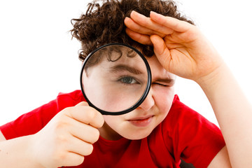 Boy looking through magnifying glass isolated on white