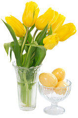 Eggs in bowl and tulips in vase isolated on white
