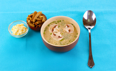 Tasty soup on blue tablecloth