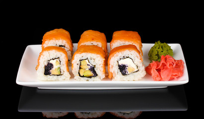 Tasty rolls served on white plate isolated on black