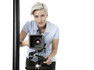 Pretty young photographer with her camera takes a photo