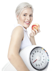 Pretty woman with scale is happy to lose weight