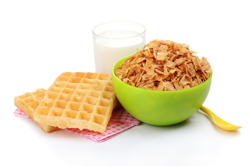 tasty cornflakes in green bowl and glass of milk isolated