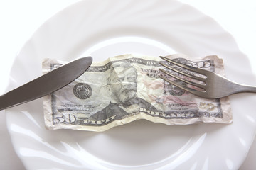 dollar bill on white dish 