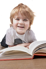 happy little boy reading and smiling