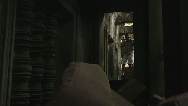 Male tourist walking inside Beng Mealea temple, Cambodia, Asia