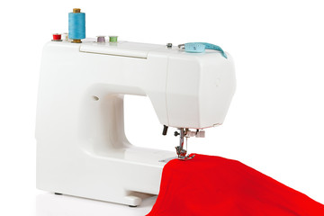 Sewing machine with a red fabric on a white background