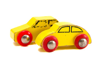 isolated two old wooden cars toys