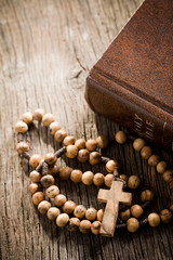 wooden rosary and the Bible