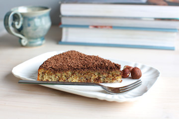 Hazelnut cake with chocolate shavings on white plate
