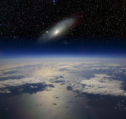 The Earth in space and the Andromeda galaxy.