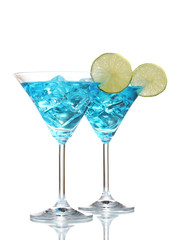 Blue cocktail in martini glasses with ice isolated on white
