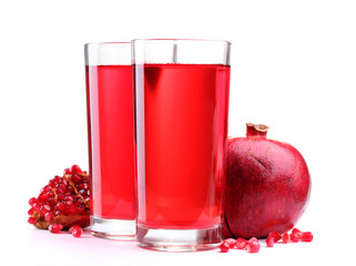 ripe pomergranate and glasses of juice isolated on white.